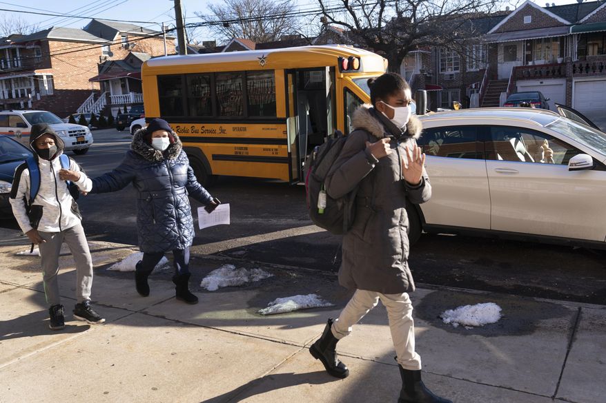 Students arrive at Meyer Levin Middle School, Thursday, Feb. 25, 2021, in New York. In-school learning resumed for middle school students in New York City for the first time since the fall of 2020. (AP Photo/Mark Lennihan)