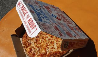 FILE - This July 15, 2019, file photo shows a small Domino&#39;s pizza made in a Domino&#39;s Pizza shop in downtown Pittsburgh.  After a pandemic-fueled boom, U.S. pizza sales appear to be headed back to Earth. Domino’s and Papa John’s pizza chains both said Thursday, Feb. 25, 2021,  that their same-store sales lost steam in the fourth quarter compared to the huge increases they saw earlier in 2020.    (AP Photo/Gene J. Puskar, File)