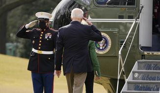 President Joe Biden salutes before boarding Marine One with first lady Jill Biden at the White House in Washington, Friday, Feb. 26, 2021, for a short trip to Andrews Air Force Base, Md., and then on to Houston. (AP Photo/Andrew Harnik)