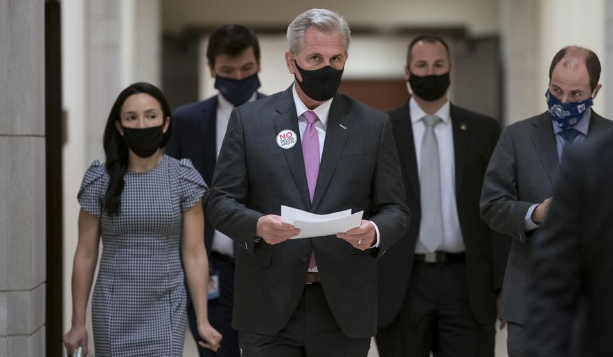House Minority Leader Kevin McCarthy, R-Calif., arrives for a news conference where he criticized Speaker of the House Nancy Pelosi, D-Calif., and the Democratic $1.9 trillion COVID relief package, during a news conference at the Capitol in Washington, Friday, Feb. 26, 2021. (AP Photo/J. Scott Applewhite)
