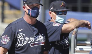 Atlanta Braves Hall of Fame third baseman Chipper Jones and manager Brian Snitker watch batting practice during spring baseball training Tuesday, Feb. 23, 2021, in North Port, Fla. (Curtis Compton/Atlanta Journal-Constitution via AP)