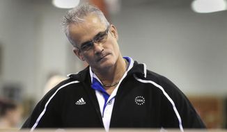 John Geddert watches his students during practice in December 2011. Geddert, a former U.S. Olympics gymnastics coach with ties to disgraced sports doctor Larry Nassar, killed himself Thursday, Feb. 25, 2021, hours after being charged with turning his Michigan gym into a hub of human trafficking by coercing girls to train and then abusing them. Geddert faced 24 charges that could have carried years in prison had he been convicted. (Greg DeRuiter/Lansing State Journal via AP)