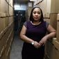 Fulton County District Attorney Fani Willis poses among boxes containing thousands of primal cases at her office, Wednesday, Feb. 24, 2021, in Atlanta. (AP Photo/John Bazemore)