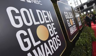FILE - Event signage appears above the red carpet at the 77th annual Golden Globe Awards, on Jan. 5, 2020, in Beverly Hills, Calif. The 78th annual Golden Globes will be held on Sunday, Feb. 18, 2021. (Photo by Jordan Strauss/Invision/AP, File)