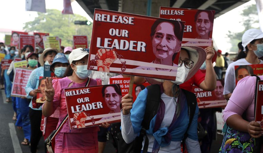 University teachers march with the images of deposed Myanmar leader Aung San Suu Kyi in Yangon, Myanmar, Friday, Feb. 26, 2021. Supporters of Myanmar’s junta attacked people protesting the military government that took power in a coup, using slingshots, iron rods and knives Thursday to injure several of the demonstrator (AP Photo) (AP Photo)