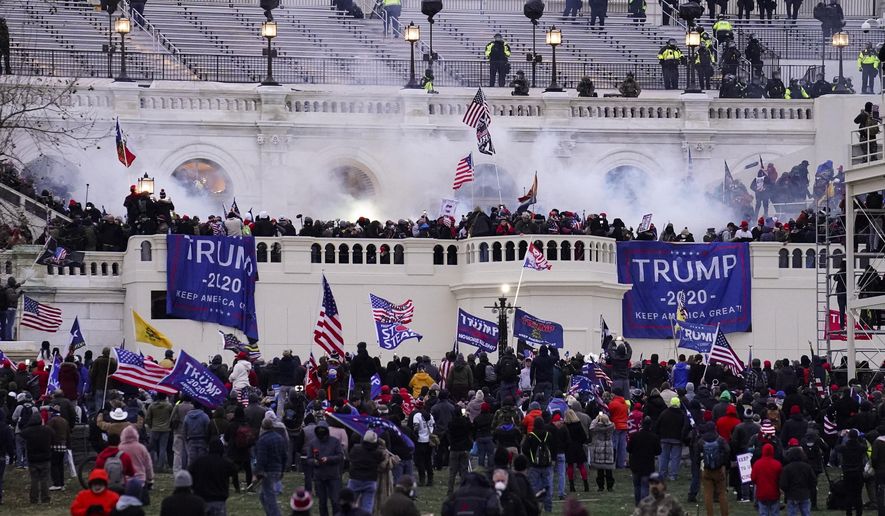 In this Wednesday, Jan. 6, 2021, file photo, rioters storm the Capitol, in Washington. (AP Photo/John Minchillo, File)