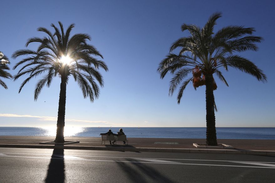FILE - In this Jan. 16, 2016 file photo people take rest on the Promenade des Anglais, in Nice, southeastern France. Residents of the French Riviera city of Nice won't be allowed to enjoy a walk on the beach on a sunny weekend after authorities have decided to implement a local, temporary lockdown to try to curb the spread of the virus. (AP Photo/Lionel Cironneau, File)