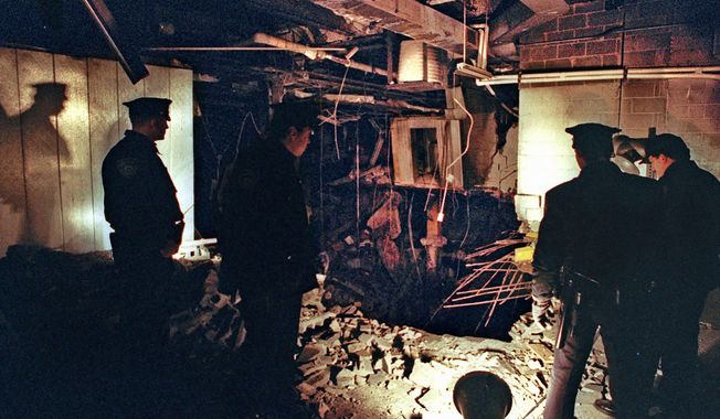 FILE - In this Feb. 27, 1993, file photo, Port Authority and New York City Police officers view the damage caused by a truck bomb that exploded in the garage of New York&#x27;s World Trade Center the previous day. Decades after going to prison, some of the men responsible for the World Trade Center bombing that killed six people 28 years ago Friday, Feb. 26, 2021, are still trying to whittle down their onetime life sentences on the remote chance that they could someday be freed. (AP Photo/Richard Drew, File)