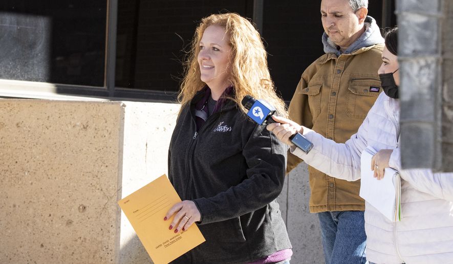 In this Jan. 13, 2021 file photo, Jenny Cudd, a flower shop owner and former Midland mayoral candidate, and Eliel Rosa leave the federal courthouse in Midland, Texas. (Jacob Ford/Odessa American via AP, File)