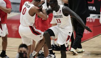 San Diego State forward Keshad Johnson (0) and forward Aguek Arop (33) celebrate after a 62-58 win over Boise State in an NCAA college basketball game Saturday, Feb 27, 2021, in San Diego. (AP Photo/Gregory Bull)