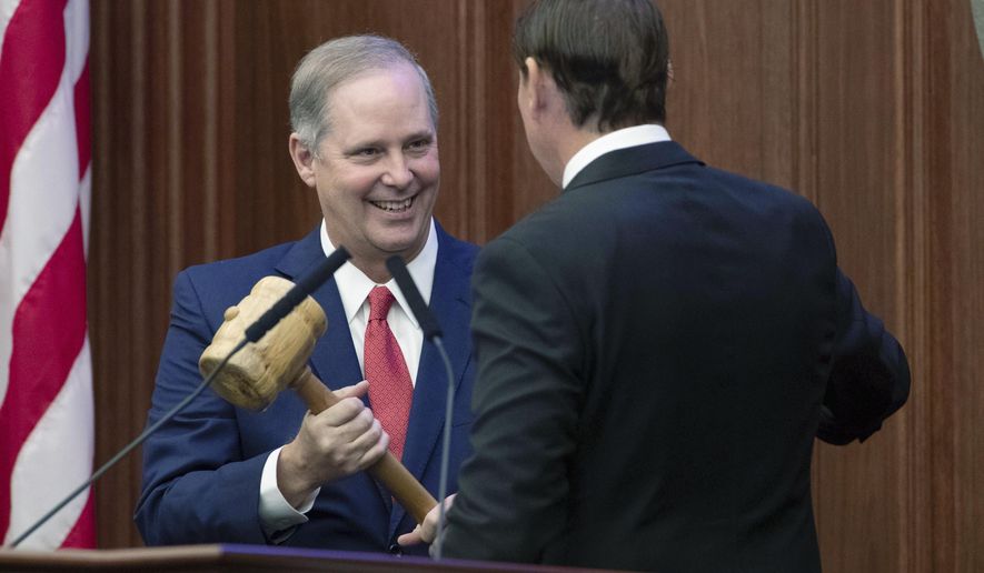 Outgoing Senate President Bill Galvano hands the gavel over to new Senate President Wilton Simpson during the Florida Legislature's Organization Session in Tallahassee, Fla., Tuesday, Nov. 17, 2020. Lawmakers begin their annual 60-day session on Tuesday, March 2, 2021 facing budget uncertainties and COVID-19 complications and with new leadership in the House and Senate. (Tori Lynn Schneider/Tallahassee Democrat via AP, File)