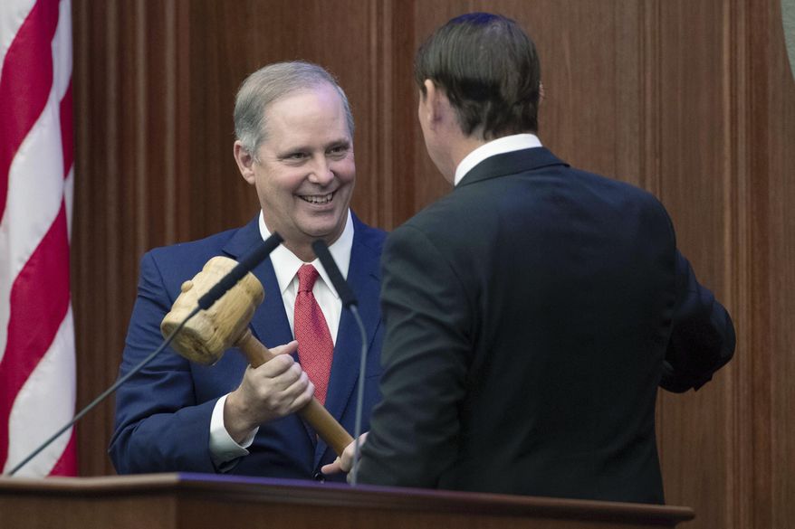 Outgoing Senate President Bill Galvano hands the gavel over to new Senate President Wilton Simpson during the Florida Legislature's Organization Session in Tallahassee, Fla., Tuesday, Nov. 17, 2020. Lawmakers begin their annual 60-day session on Tuesday, March 2, 2021 facing budget uncertainties and COVID-19 complications and with new leadership in the House and Senate. (Tori Lynn Schneider/Tallahassee Democrat via AP, File)