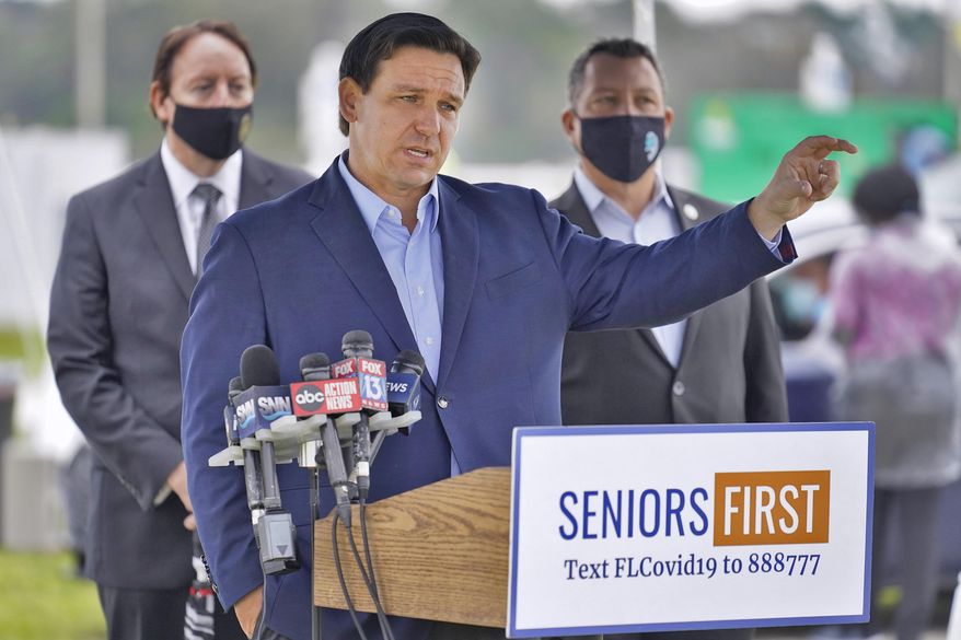 FILE- Florida Gov. Ron DeSantis gestures as he speaks to the media at a coronavirus vaccination site at Lakewood Ranch Wednesday, Feb. 17, 2021, in Bradenton, Fla. Coronavirus, budget questions, anti-riot legislation and an attempt to reign in large technology companies will be among issues lawmakers will take up in their 60-day session that begins Tuesday, March 2. (AP Photo/Chris O'Meara, File)