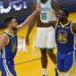 Golden State Warriors guard Stephen Curry, left, celebrates with forward Draymond Green (23) during the first half of an NBA basketball game against the Charlotte Hornets in San Francisco, Friday, Feb. 26, 2021. (AP Photo/Jeff Chiu)