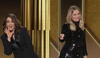 In this video grab issued Sunday, Feb. 28, 2021, by NBC, hosts Tina Fey, left, from New York, and Amy Poehler, from Beverly Hills, Calif., speak at the Golden Globe Awards. (NBC via AP)