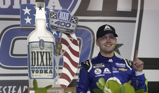 William Byron celebrates after winning a NASCAR Cup Series auto race, Sunday, Feb. 28, 2021, in Homestead, Fla. (AP Photo/Wilfredo Lee)