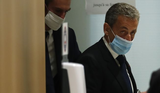 Former French President Nicolas Sarkozy leaves the courtroom in Paris, Monday, March 1, 2021. (AP Photo/Michel Euler)