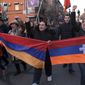 Opposition demonstrators carrying Armenian national and the separatist region of Nagorno-Karabakh’s flag, right, march to the government buildings during a rally to pressure Armenian Prime Minister Nikol Pashinyan to resign in Yerevan, Armenia, Saturday, Feb. 27, 2021. The developments come after months of protests sparked by the nation&#39;s defeat in the Nagorno-Karabakh conflict with Azerbaijan. (Hrant Khachatryan/PAN Photo via AP)
