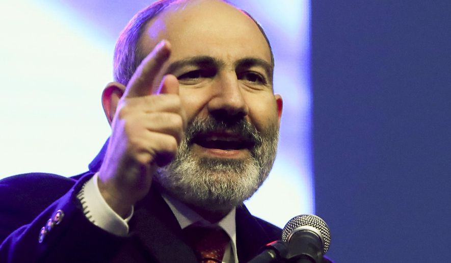 Armenian Prime Minister Nikol Pashinyan gestures while addressing his supporters during a rally in his support in the center of Yerevan, Armenia, Monday, March 1, 2021. Amid escalating political tensions in Armenia, supporters of the country&#x27;s embattled prime minister and the opposition are staging massive rival rallies in the capital of Yerevan. Prime Minister Nikol Pashinyan has faced opposition demands to resign since he signed a peace deal in November that ended six weeks of intense fighting with Azerbaijan over the Nagorno-Karabakh region. (Hayk Baghdasaryan/PHOTOLURE via AP)
