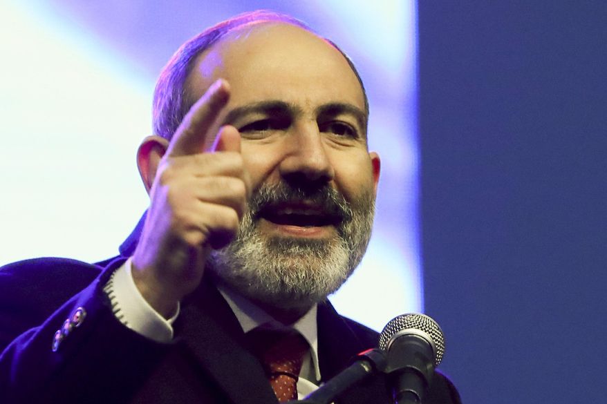 Armenian Prime Minister Nikol Pashinyan gestures while addressing his supporters during a rally in his support in the center of Yerevan, Armenia, Monday, March 1, 2021. Amid escalating political tensions in Armenia, supporters of the country&#x27;s embattled prime minister and the opposition are staging massive rival rallies in the capital of Yerevan. Prime Minister Nikol Pashinyan has faced opposition demands to resign since he signed a peace deal in November that ended six weeks of intense fighting with Azerbaijan over the Nagorno-Karabakh region. (Hayk Baghdasaryan/PHOTOLURE via AP)