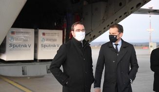 Slovak Prime Minister Igor Matovic, right, and Health Minister Marek Krajci at Kosice Airport, Slovakia, Monday March 1, 2021, as Russia&#39;s Sputnik V coronavirus vaccine arrives. Hard-hit Slovakia signed a deal to acquire 2 million dozes of Russia’s Sputnik V coronavirus vaccine. The country&#39;s prime minister says Slovakia will get one million shots in next two months while another million will arrive in May and June. (Frantisek Ivan/TASR via AP)