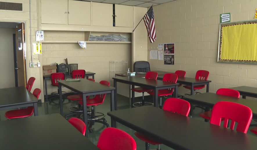 In this image made from video, an empty classroom is shown at David Ellis Academy in Detroit, Monday, Feb. 8, 2021. It&#x27;s coming up on a year since most of the students at the pre-K through 8th grade public charter school last had an in-person school day. (AP Photo/Mike Householder) ** FILE **