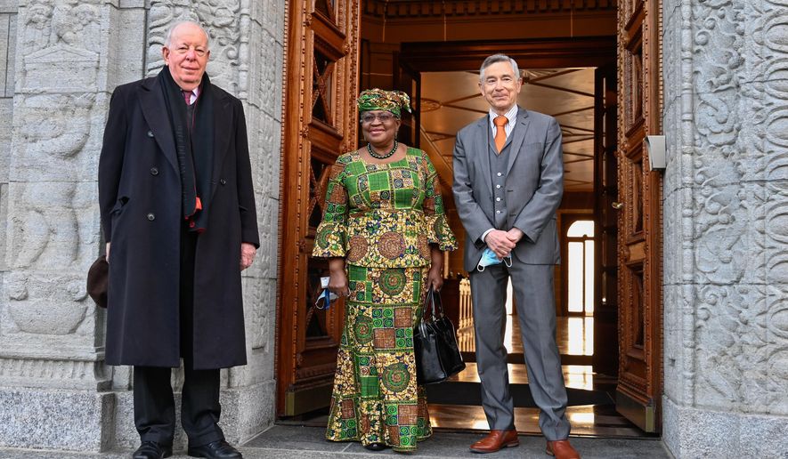 New Director-General of the World Trade Organisation Ngozi Okonjo-Iweala, center, poses between WTO Deputy Directors-General Alan Wolff, left, and Karl Brauner upon her arrival at the WTO headquarters to takes office in Geneva, Switzerland, Monday, March 1, 2021. Nigeria&#39;s Ngozi Okonjo-Iweala takes the reins of the WTO amid hope she will infuse the beleaguered body with fresh momentum to address towering challenges and a pandemic-fuelled global economic crisis. (Fabrice Coffrini/Pool/Keystone via AP)
