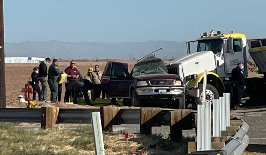 In this image from KYMA, law enforcement work at the scene of a deadly crash involving a semitruck and an SUV in Holtville, Calif., on Tuesday, March 2, 2021. (KYMA via AP)