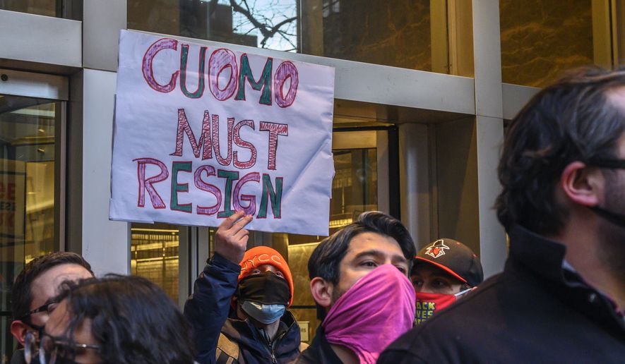 Demonstrators rally for New York Gov. Andrew Cuomo&#39;s resignation in front of his Manhattan office in New York, Tuesday, March 2, 2021. Cuomo has avoided public appearances for days as some members of his own party call for him to resign over sexual harassment allegations. (AP Photo/Brittainy Newman)