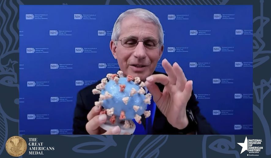 This image from video provided by Smithsonian&#x27;s National Museum of American History shows Dr. Anthony Fauci, director of the National Institute of Allergy and Infectious Diseases and chief medical adviser to the president, holding his personal 3D model of the COVID-19 virus he is donating to the Smithsonians National Museum of American History on Tuesday, March 2, 2020. Fauci presented the donation Tuesday night in a virtual ceremony to honor him with the &amp;#160;museums Great Americans Medal.  (Smithsonian&#x27;s National Museum of American History via AP)