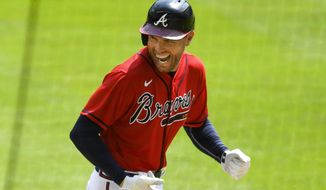 FILE - Atlanta Braves&#39; Freddie Freeman reacts as he runs along the third base line after hitting a grand slam home run in the sixth inning of a baseball game against the Washington Nationals in Atlanta, in this Sunday, Sept. 6, 2020, file photo. NL MVP Freddie Freeman has followed his big season with the Atlanta Braves with an even more memorable offseason. He and his wife have two baby boys, including one from a surrogate mother. He calls his new babies his “twins with a twist.”(AP Photo/John Amis, File)