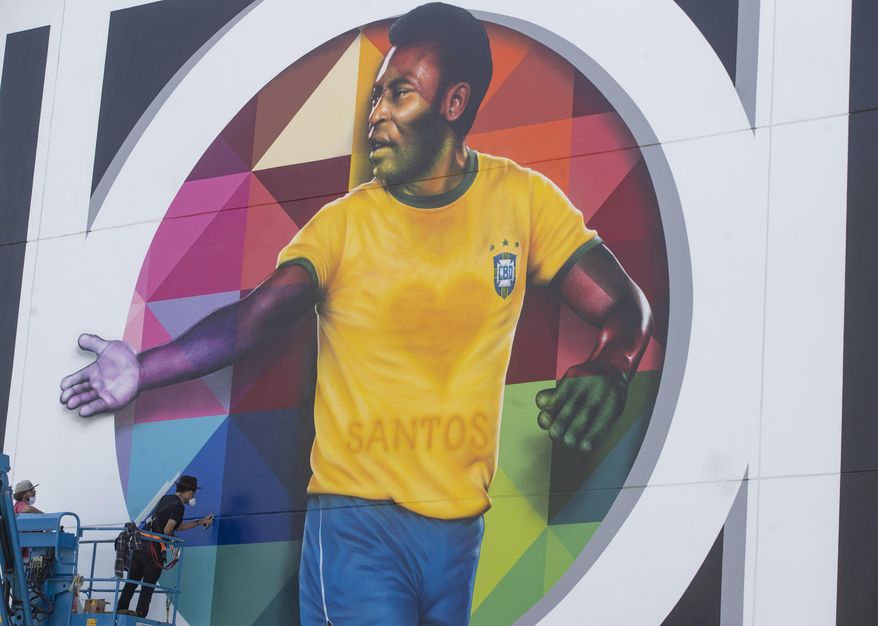 Brazilian street artist Eduardo Kobra spray paints the finishing touches to his mural to pay homage to soccer legend Pele to mark his 80th birthday in the coastal city of Santos, Brazil, Sunday, Oct. 18, 2020. Pele&#x27;s birthday is Oct. 23. (AP Photo/Andre Penner)