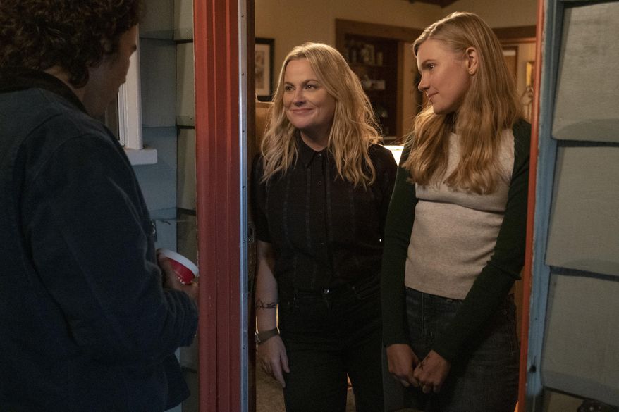 Nico Hiraga, from left, Amy Poehler and Hadley Robinson appear in a scene from "Moxie," debuting Wednesday on Netflix. (Colleen Hayes/Netflix via AP)