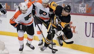 Pittsburgh Penguins&#39; Mike Matheson (5) tries to control the puck as Philadelphia Flyers&#39; Travis Konecny (11) and Connor Bunnaman (82) pursue during the second period of an NHL hockey game, Tuesday, March 2, 2021, in Pittsburgh. (AP Photo/Keith Srakocic)