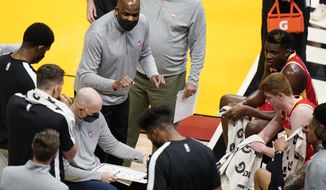 Atlanta Hawks interim coach Nate McMillan, center, gestures as he talks to players during a timeout in the first half of the team&#x27;s NBA basketball game against the Miami Heat, Tuesday, March 2, 2021, in Miami. His opportunity to return to a head coach position comes with mixed feelings following Monday&#x27;s firing of his friend, Lloyd Pierce. (AP Photo/Wilfredo Lee)