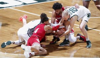 Michigan State&#39;s Joshua Langford, left, and Joey Hauser (20) and Indiana&#39;s Khristian Lander (4), Jerome Hunter, right rear, and Trey Galloway, center (obscured) vie for the ball during the first half of an NCAA college basketball game, Tuesday, March 2, 2021, in East Lansing, Mich. (AP Photo/Al Goldis)