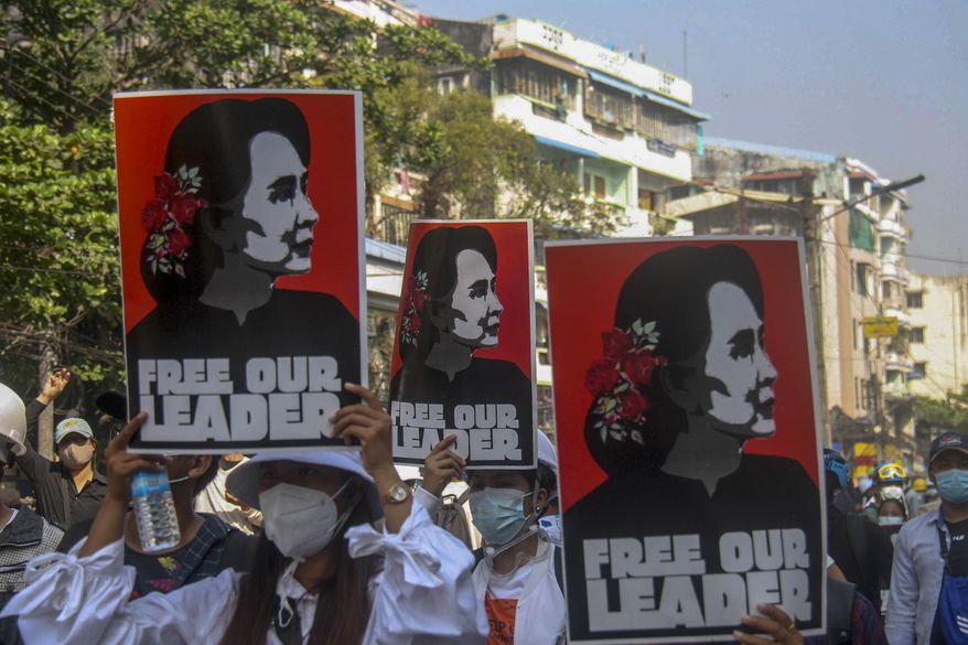 Anti-coup protesters display pictures of deposed Myanmar leader Aung San Suu Kyi in Yangon, Myanmar, Tuesday, March 2, 2021. Police in Myanmar repeatedly used tear gas and rubber bullets Tuesday against crowds protesting last month&#x27;s coup, but the demonstrators regrouped after each volley and tried to defend themselves with barricades as standoffs between protesters and security forces intensified. (AP Photo)