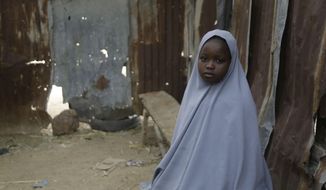 Student Amtallahi Lawal, 11, who hid under her bed and managed to escape when gunmen abducted more than 300 girls from her boarding school on Friday, recounts her ordeal at her house in Jangebe town, Zamfara state, northern Nigeria, Monday, March 1, 2021. Families in Nigeria waited anxiously on Monday for news of their abducted daughters, the latest in a series of mass kidnappings of school students in the West African nation. (AP Photo/Sunday Alamba)