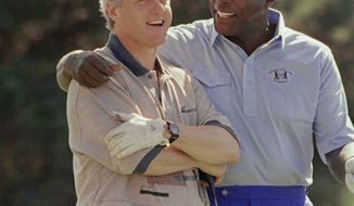 FILE- In this Aug. 22, 1993 file photo, President Bill Clinton receives some consoling advice from White House advisor and golf partner Vernon Jordan after Clinton hit a bad shot during their golf math at the Farm Neck Golf Club in Oak Bluffs, Mass., on Martha&#39;s Vineyard.  Jordan, who rose from humble beginnings in the segregated South to become a champion of civil rights before reinventing himself as a Washington insider and corporate influencer, died Tuesday, March 2, 2021, according to a statement from his daughter. He was 85. (AP Photo/Marcy Nighswander, File)