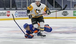 New York Islanders center Anders Lee (27) falls to the ice after colliding with Pittsburgh Penguins center Sidney Crosby (87) during the second period of an NHL hockey game, Sunday, Feb. 28, 2021, in Uniondale, N.Y. (AP Photo/Kathy Willens)
