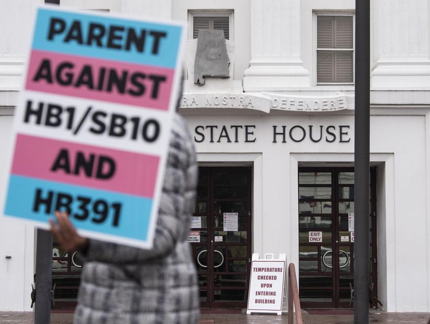 Protestors in support of transgender rights march around the Alabama State House in Montgomery, Ala., on Tuesday, March 2, 2021. (Jake Crandall//The Montgomery Advertiser via AP)