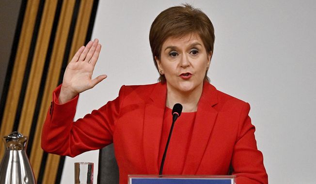 First Minister of Scotland Nicola Sturgeon takes the oath before giving evidence to the Committee on the Scottish Government Handling of Harassment Complaints, at Holyrood in Edinburgh, Scotland, Wednesday, March 3, 2021.  The inquiry is investigating the government’s handling of sexual harassment allegations against former leader Alex Salmond, and allegations that Sturgeon misled parliament. (Jeff J Mitchell/PA via AP)
