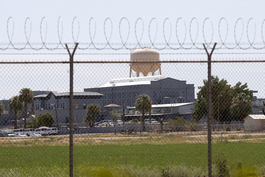 FILE - This July 23, 2014, file photo, shows a state prison in Florence, Ariz. A female Arizona corrections officer alleged in a lawsuit filed against the state on March 2, 2021, that she was subjected to a hostile environment while working at a prison where her supervisor was accused of sexually assaulting her and three other people who worked there. Corrections officials say their investigators arrested the officer after they examined the allegations and then sent the case to prosecutors. (AP Photo/File)