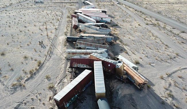 This photo provided by the San Bernardino County Fire Department shows a derailed cargo train in the Southern California desert that sent more than two dozen rail cars crashing into the sand near Ludlow, Calif., Wednesday, March 3, 2021. Nobody was hurt and there was no fire when the BNSF train went off the tracks near the remote Mojave community the San Bernardino County Fire Department said. (San Bernardino County Fire Dept. via AP)
