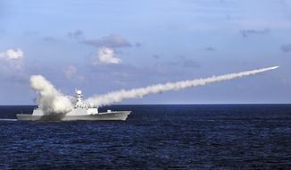 In this July 8, 2016, photo released by Xinhua News Agency, Chinese missile frigate Yuncheng launches an anti-ship missile during a military exercise in the waters near south China&#39;s Hainan Island and Paracel Islands. Ahead of the 2021 annual Congress meetings, China is continuing its military buildup and recently passed a law authorizing its coast guard to use force to remove foreign presences in what it considers Chinese waters and islands. (Zha Chunming/Xinhua via AP) **FILE**