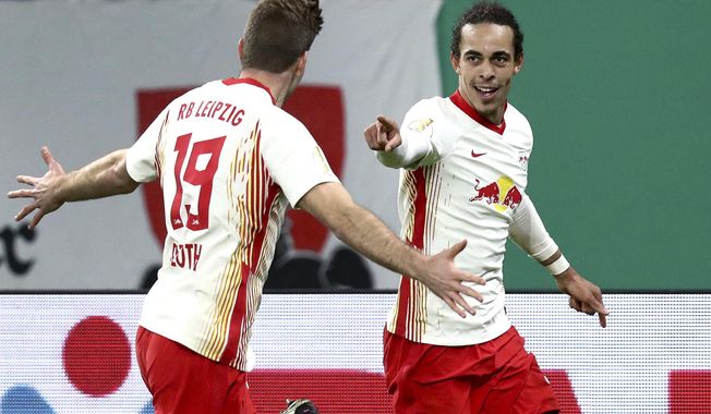 Leipzig&#x27;s scorer Yussuf Poulsen, right, and his teammate Alexander Sorloth, left, celebrate the opening goal during the German soccer cup, DFB Pokal, quarter final match between RB Leipzig and VfL Wolfsburg in Leipzig, Germany, Wednesday, March 3, 2021. (AP Photo/Michael Sohn)