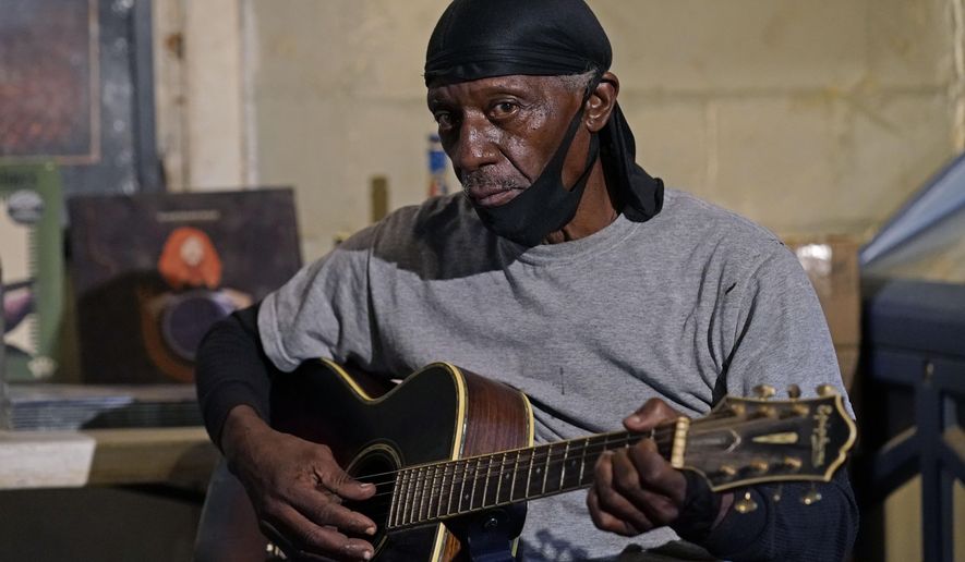 Bluesman Jimmy &amp;quot;Duck&amp;quot; Holmes plays a quick ditty at the Blue Front Cafe in Bentonia, Miss., Jan. 21, 2021. Holmes&#39; ninth album, &amp;quot;Cypress Grove,&amp;quot; has earned a Grammy nomination for the Best Traditional Blues Album. (AP Photo/Rogelio V. Solis)