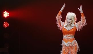FILE - Dolly Parton performs in concert on May 27, 2014, in Knoxville, Tenn. It&#39;s been 51 years since Dolly Parton earned her first Grammy nomination, and this year the national treasure who has won nine Grammys throughout her career is competing for her 50th honor. (Photo by Wade Payne/Invision/AP, File)