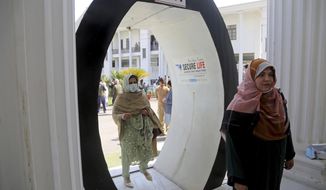 Lawmakers arrive to cast their vote in senate elections, at the provincial assembly, in Peshawar, Pakistan, Wednesday, March 3, 2021. Pakistani lawmakers are choosing new members of the country&#39;s Senate, or upper house of parliament — a vote that is seen as a test for Prime Minister Imran Khan&#39;s government. Khan&#39;s ruling Pakistan Tehreek-e-Insaf party is seeking to improve its standing in the 104-member Senate, where it lacks a majority. (AP Photo/Muhammad Sajjad)