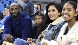 In this Nov. 21, 2017, file photo, from left, Los Angeles Lakers legend Kobe Bryant, his daughter Gianna Maria-Onore Bryant, wife Vanessa and daughter Natalia Diamante Bryant are seen before an NCAA college women&#39;s basketball game between Connecticut and UCLA, in Los Angeles. Vanessa Bryant says she is focused on “finding the light in darkness” in an emotional story in People magazine. She details how she attempts to push forward after her husband, Kobe Bryant, and daughter Gigi died in a helicopter crash in early 2020. (AP Photo/Reed Saxon, File)